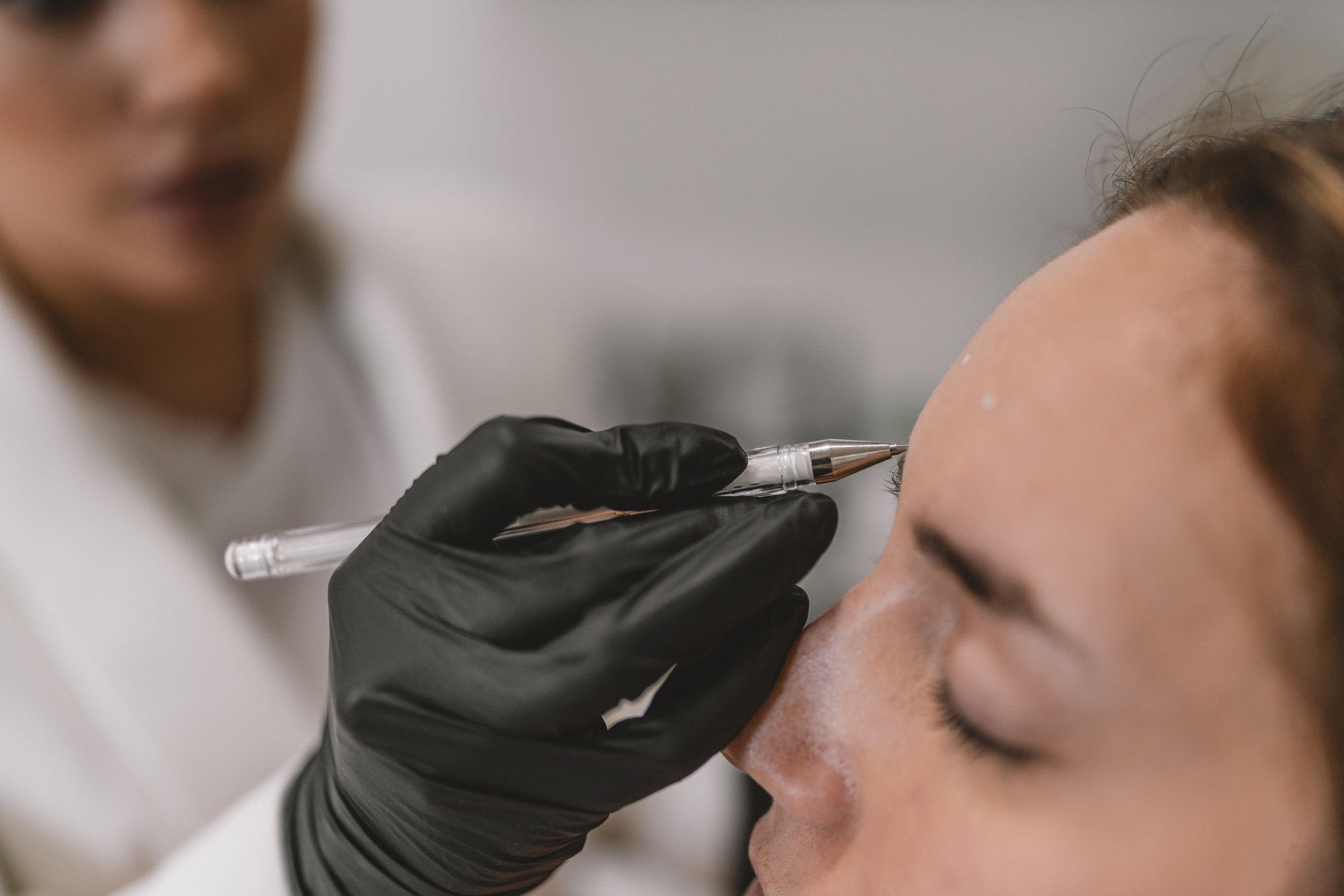 Close-up of a woman receiving a facial aesthetics surgery treatment